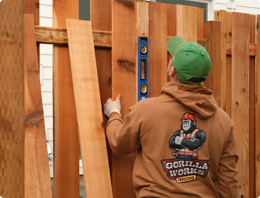 Gorilla Works installer building a wood fence