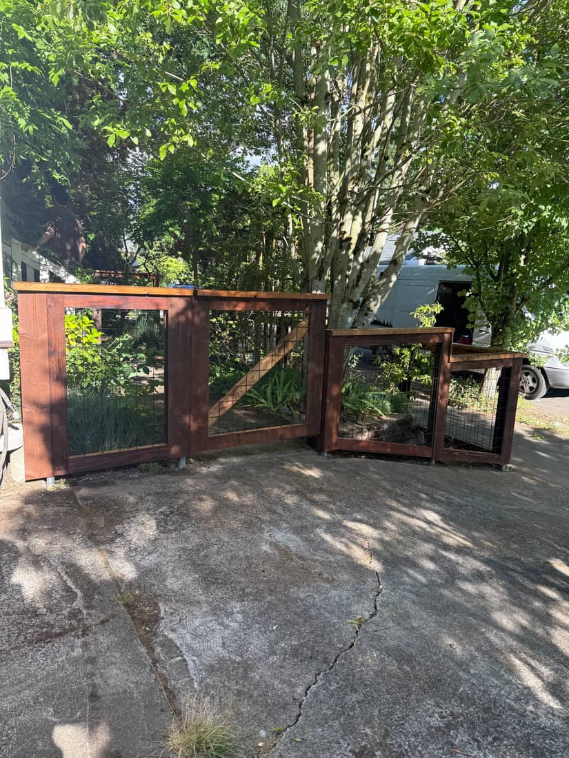 Cedar framed hog wire fence sections at the edge of a driveway in the Portland, OR area
