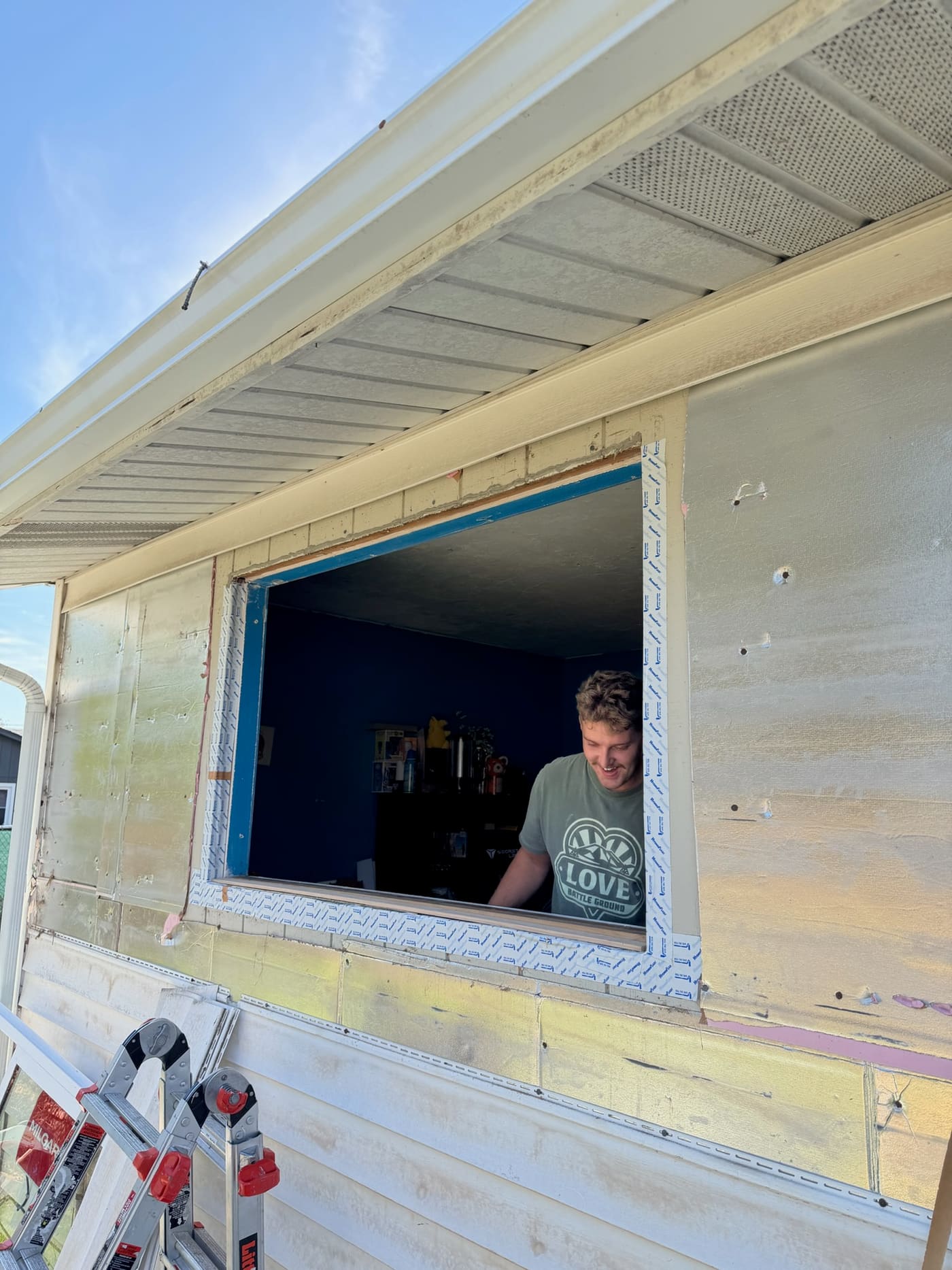A Gorilla Works crew member working in a window opening that is flashed and ready for the new window