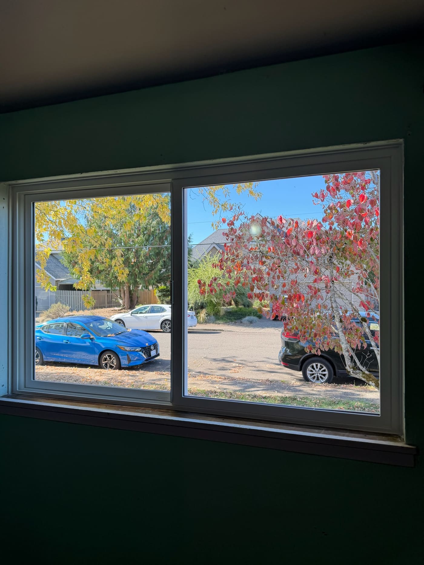 A new double-pane slider window seen from inside the room, looking out at the street