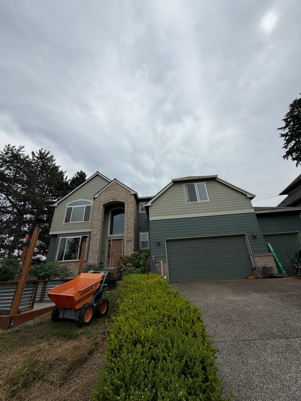 Two-tone green lap siding installed by Gorilla Works on a two-story Portland OR home