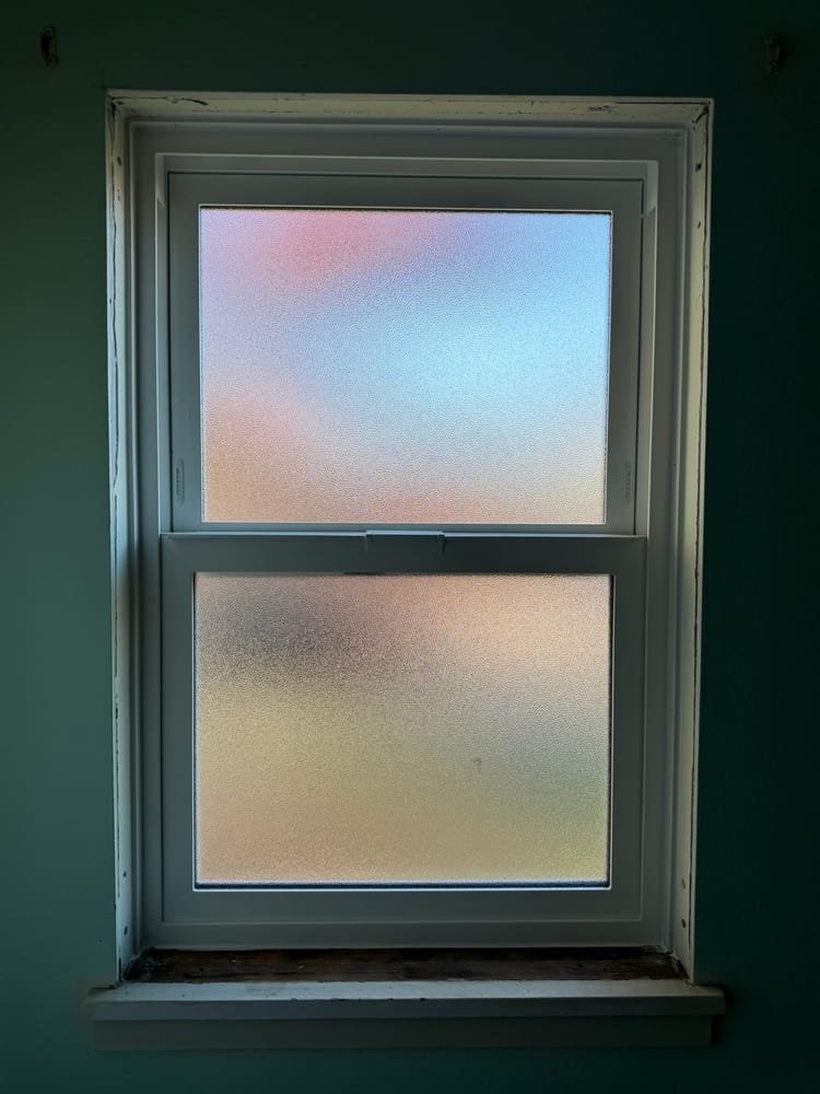 White vinyl hung window with frosted privacy glass, installed by Gorilla Works in the Portland area